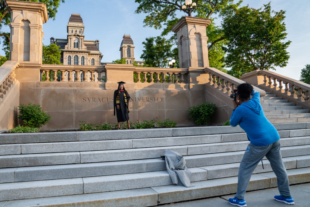 Kayla Wright, a graduate student in her robes, getting her picture taken on graduation day.