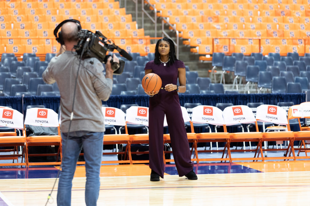 A student reporting live at a basketball game