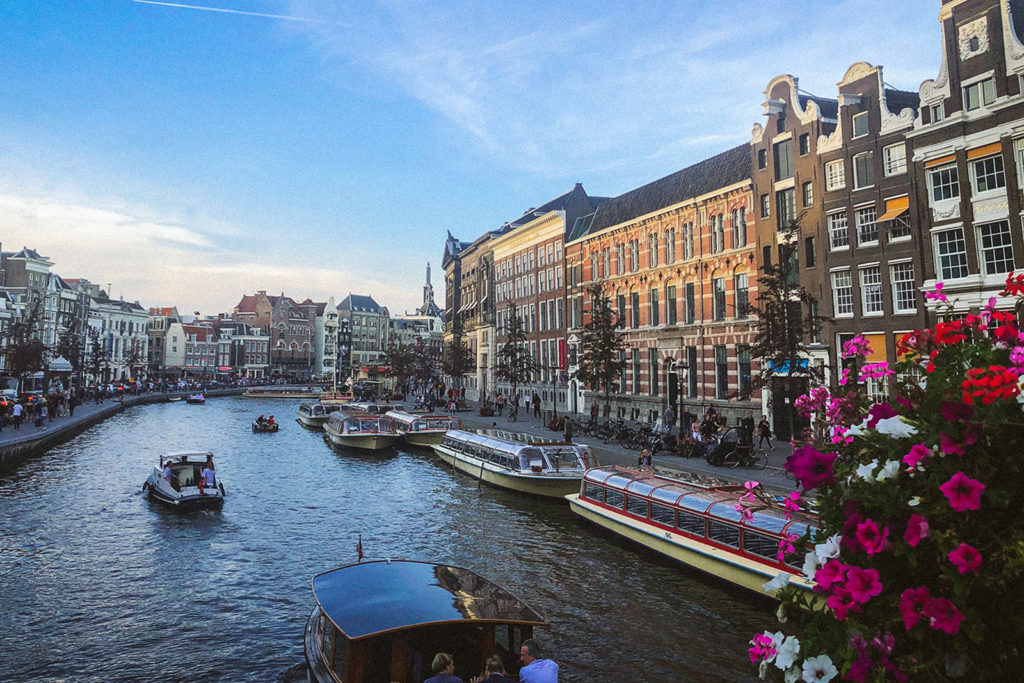 Open boat cruising in one of Amsterdam’s many canals.