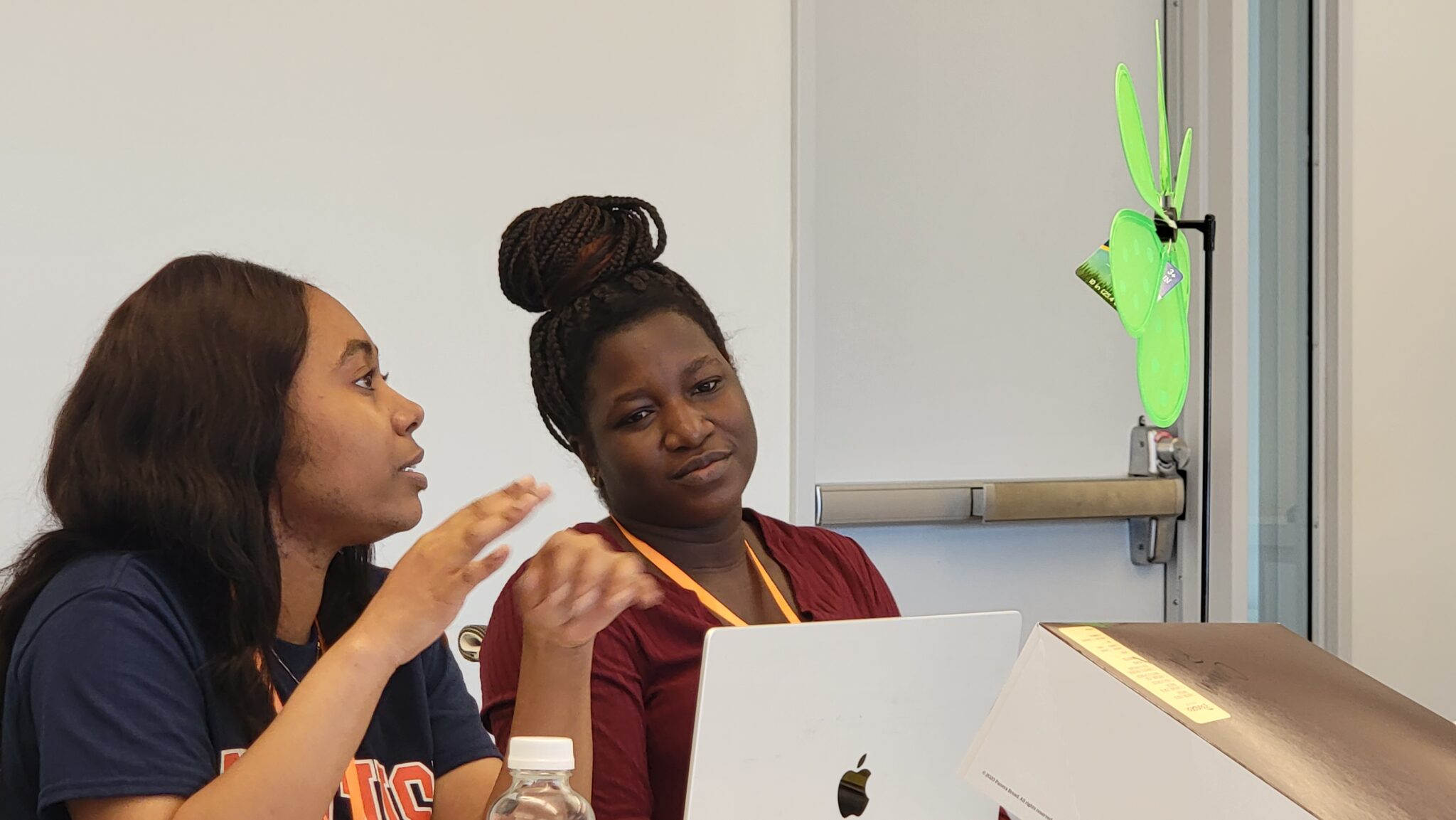 Two students work together in front of a laptop in the I-3 center at “Springboard: The Newhouse Academic Un-conference”