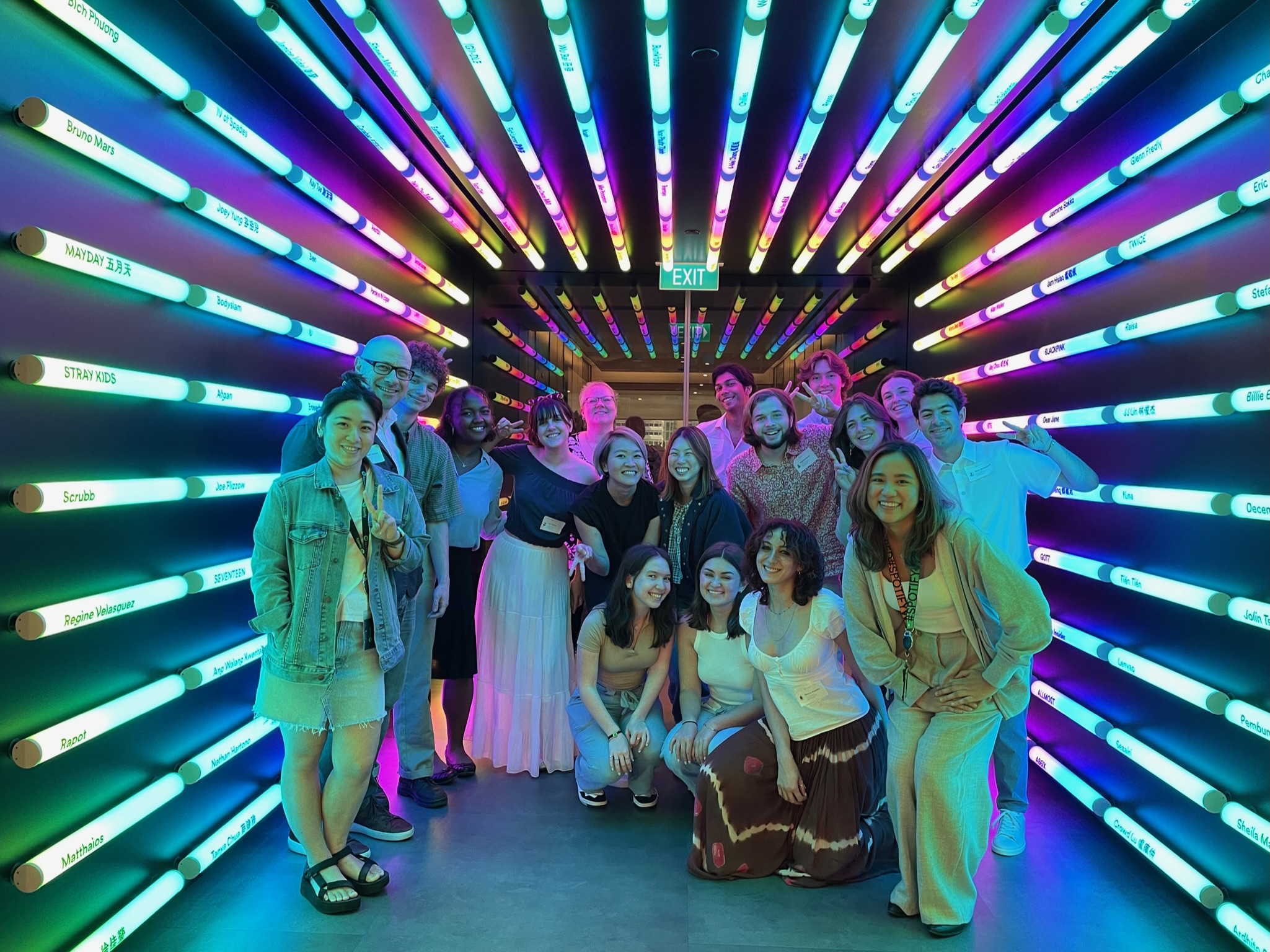 students stand in a glowing tunnel at the Spotify offices in Singapore
