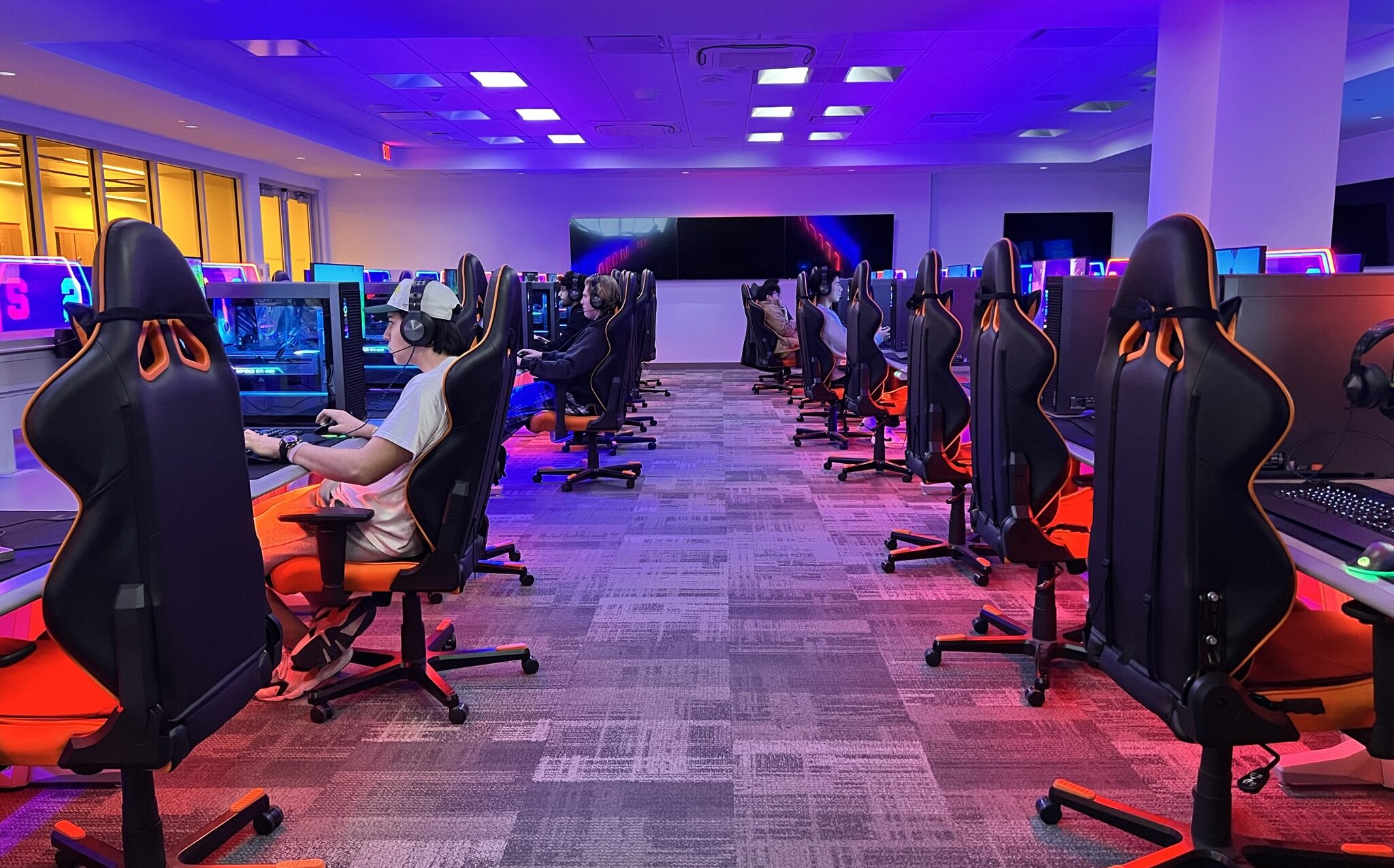 Students play video games in esports gaming room in the Barnes Center at the Arch