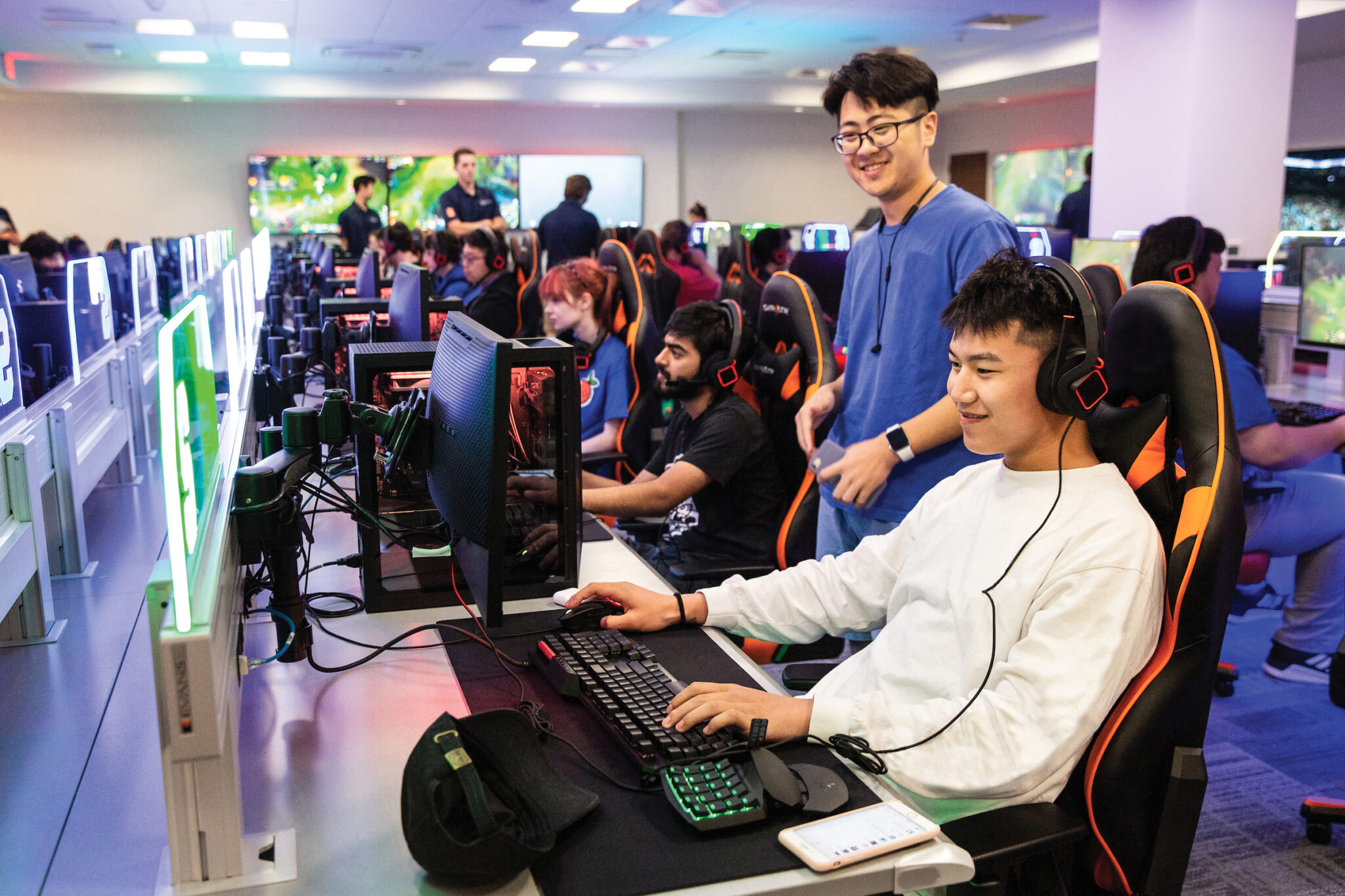 Students sit at computers in esports room playing video games