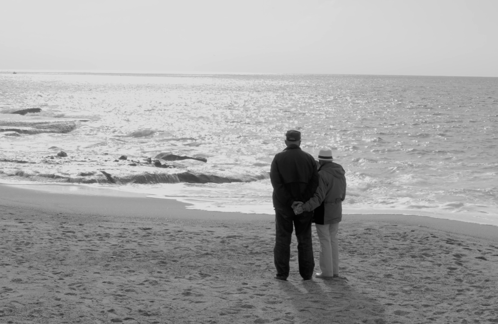 two people stand on a beach