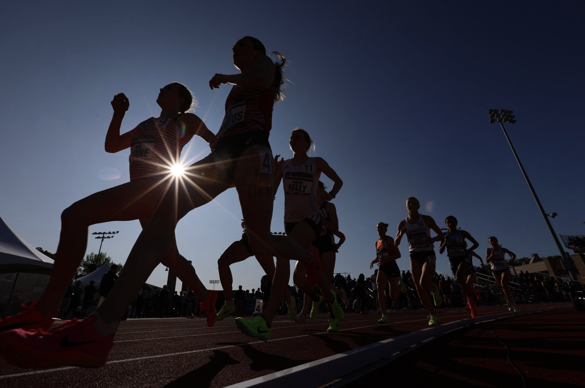 athletes run around a track