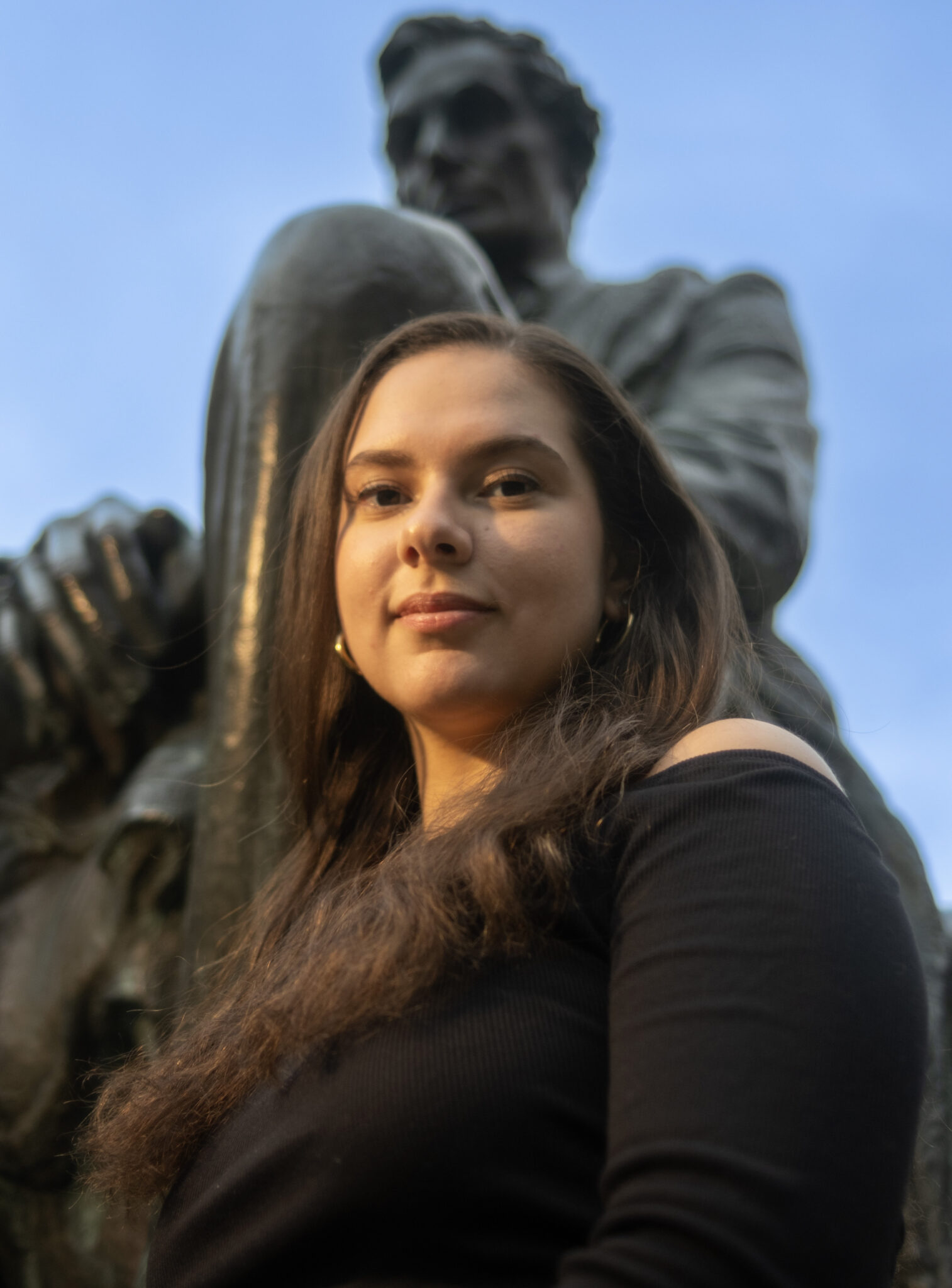 a person stands in front of a statue of abraham lincoln