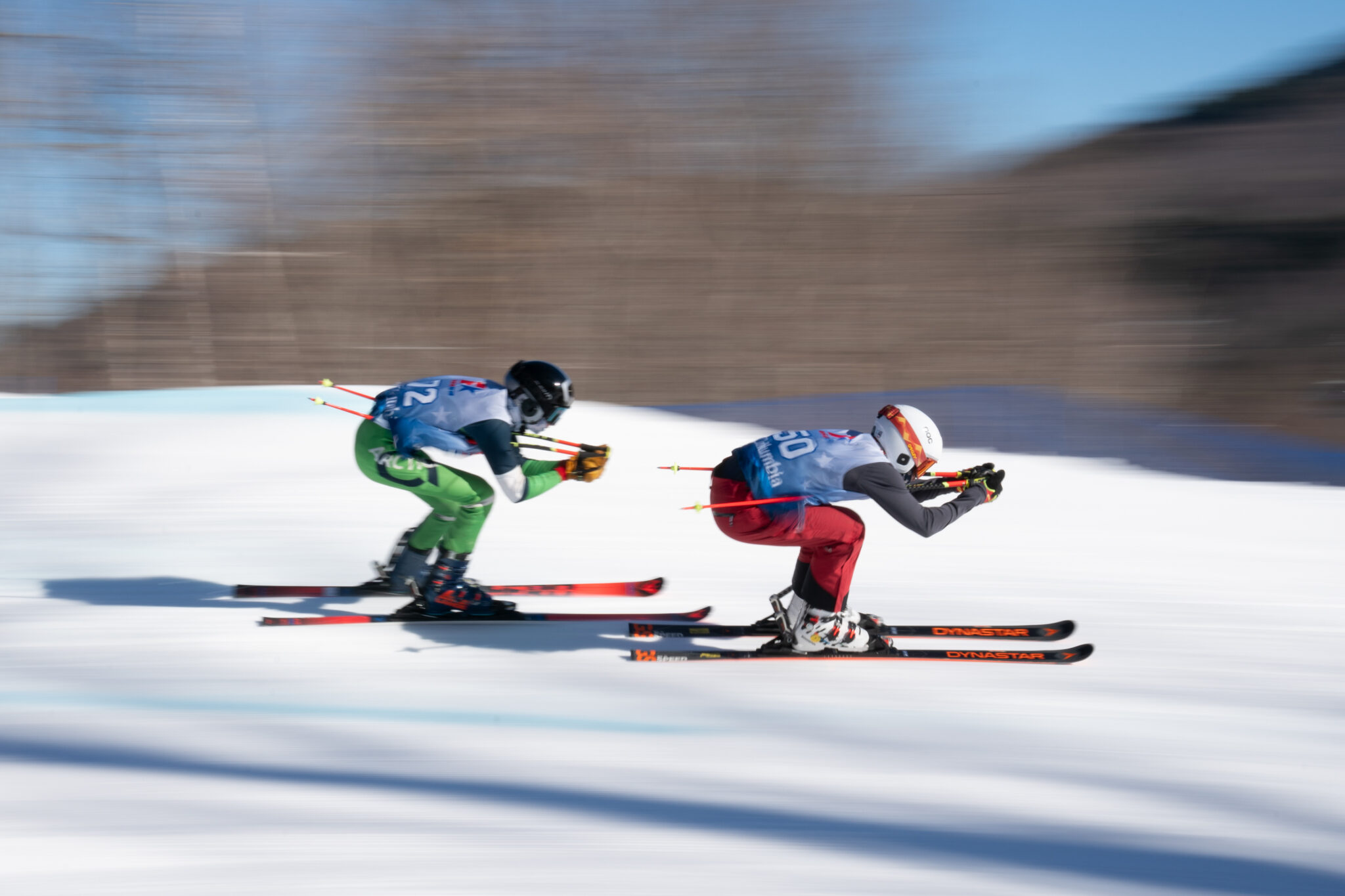 two skiers race down a mountain