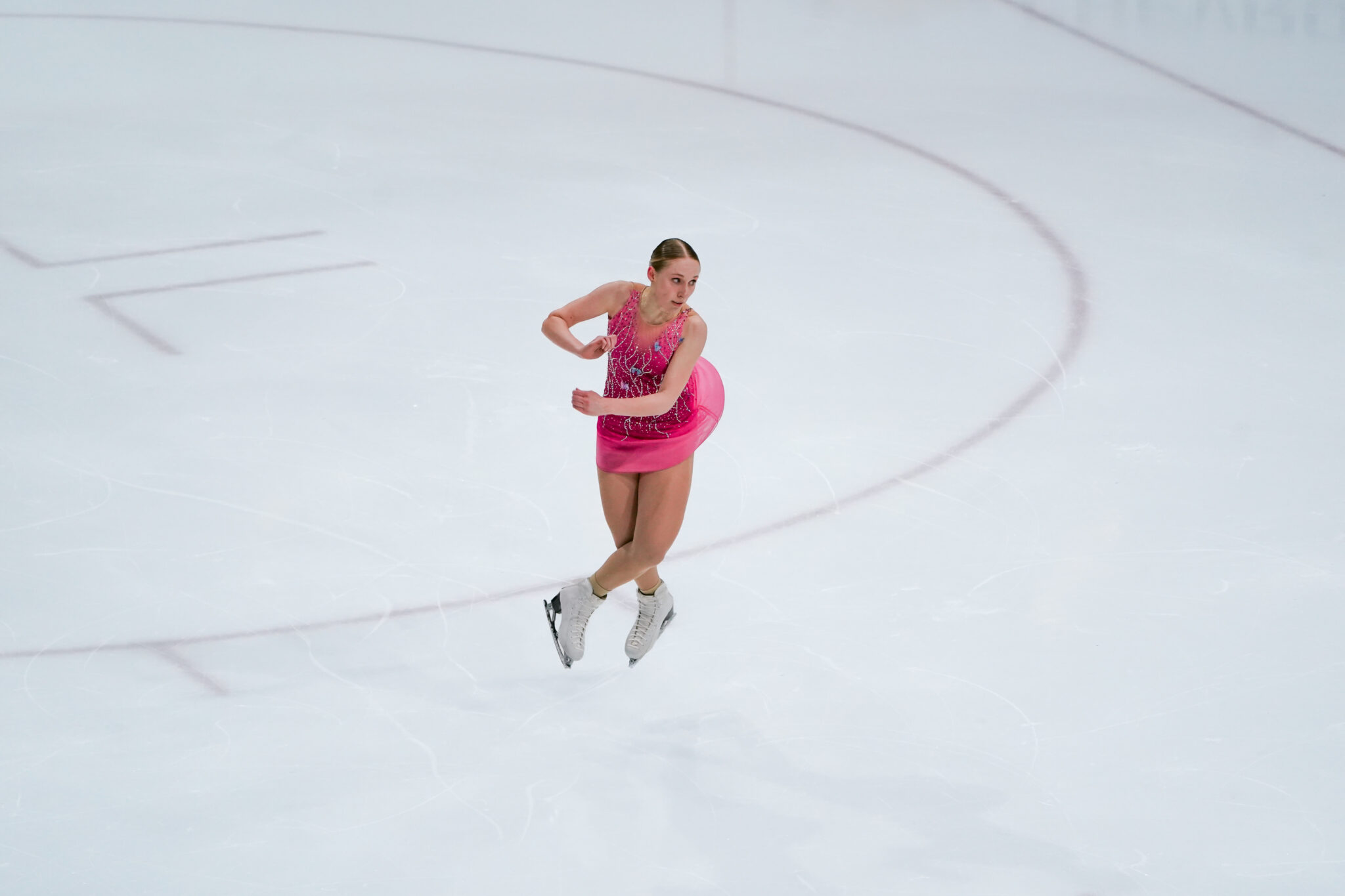 an ice skater twirls in the air 