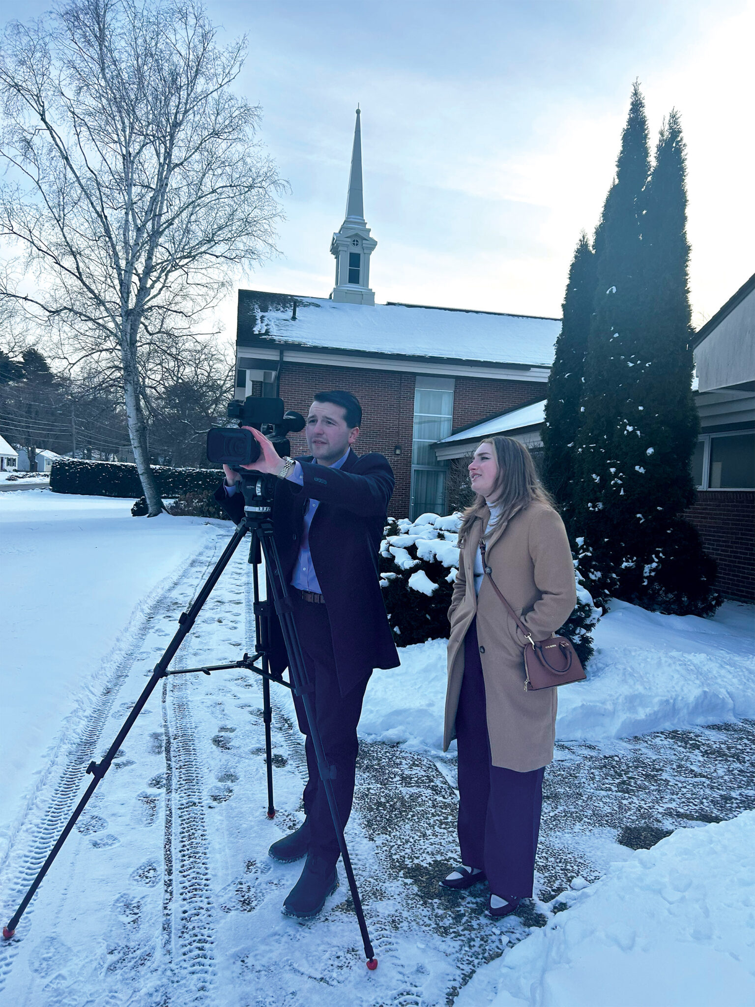 Broadcast and digital journalism junior Ronnie Parrillo (left) and senior Blythe Reis shoot b-roll at a polling site in Laconia, N.H.