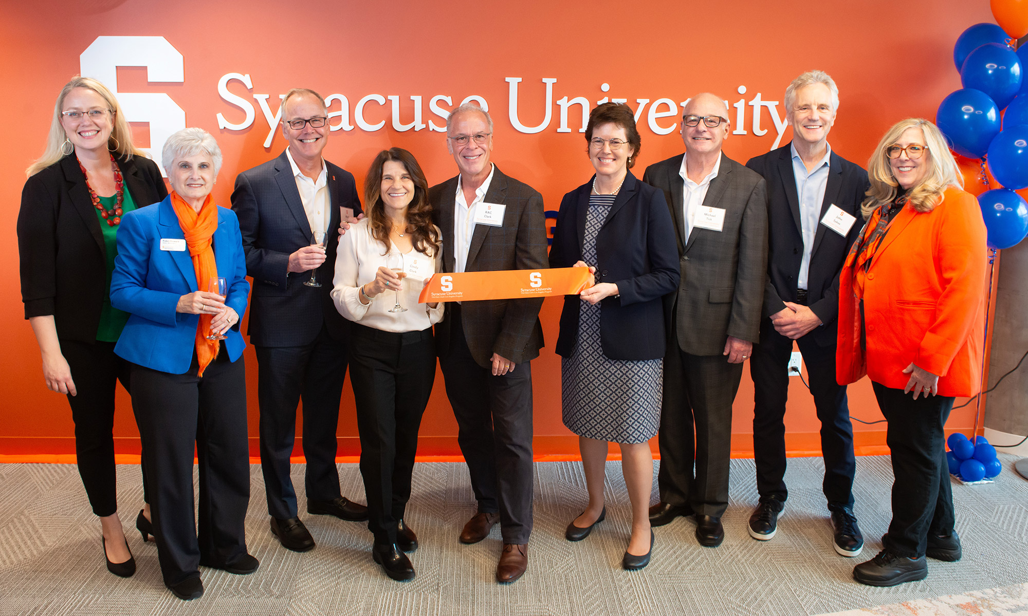 Among those celebrating at the March 2 ribbon-cutting ceremony for the new home of the Syracuse University Dick Clark Los Angeles Program are (from left) Anna Proulx, director of the College of Visual and Performing Arts (VPA) Program, LA Semester;
Robin Howard, director of the Newhouse LA program; 
Newhouse Dean Mark J. Lodato; Cindy Clark ’86; RAC Clark; Provost Gretchen Ritter; VPA Dean Michael S. Tick; John Sykes ’77, president of entertainment enterprises for iHeartMedia; and 
Joan Adler, University assistant vice president of regional programs in Los Angeles.