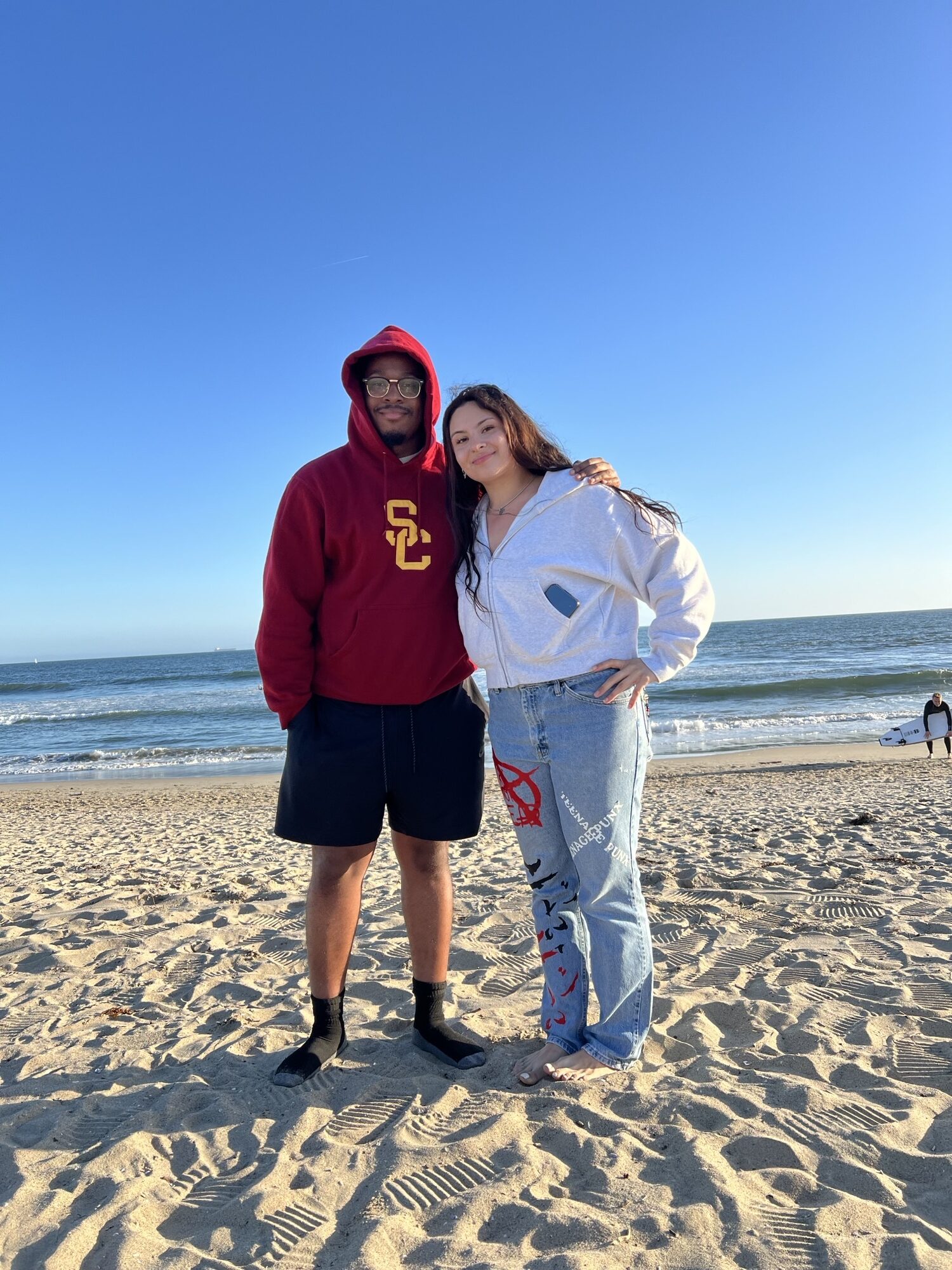 two people stand on a beach
