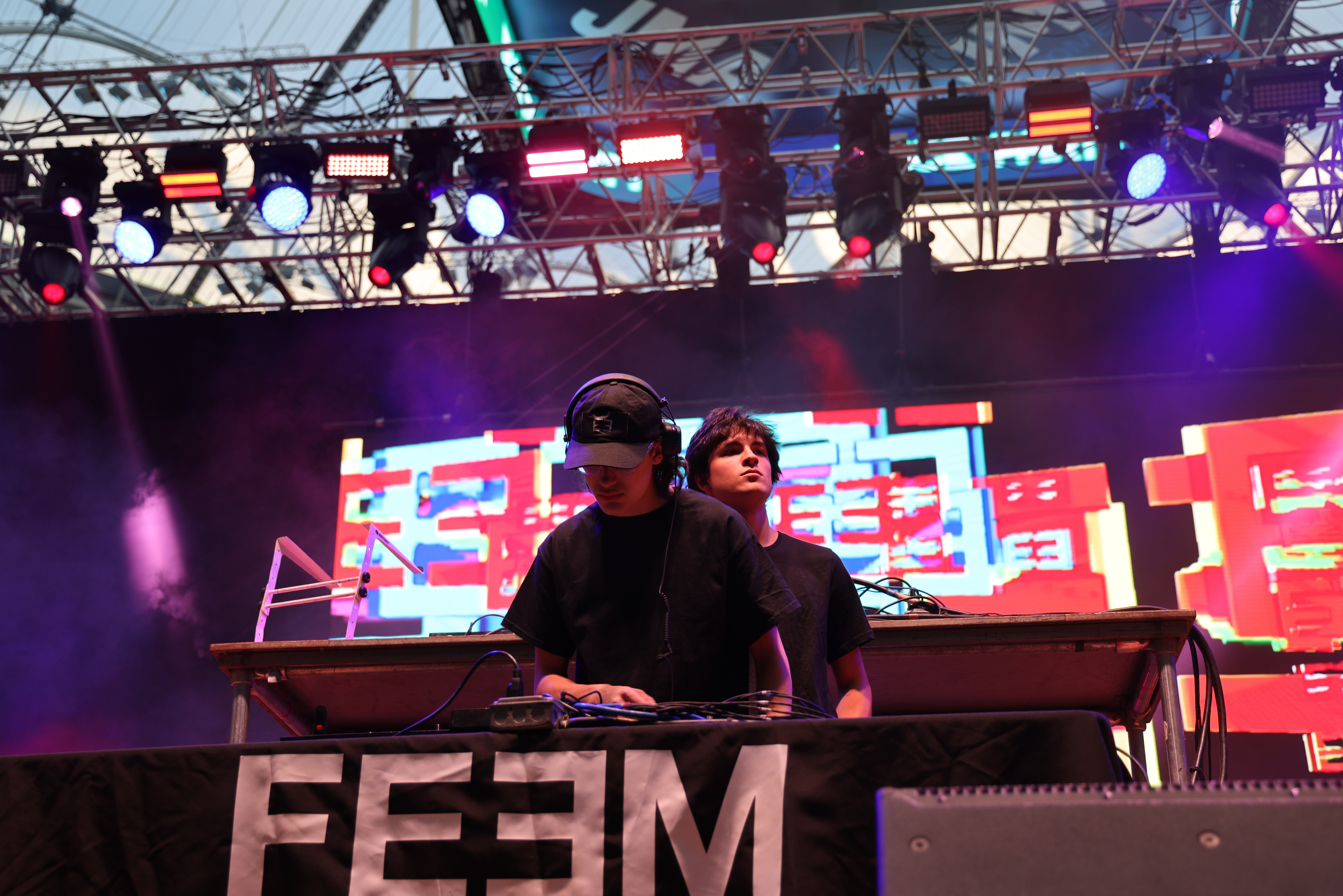 a two DJs performs on a stage at a concert