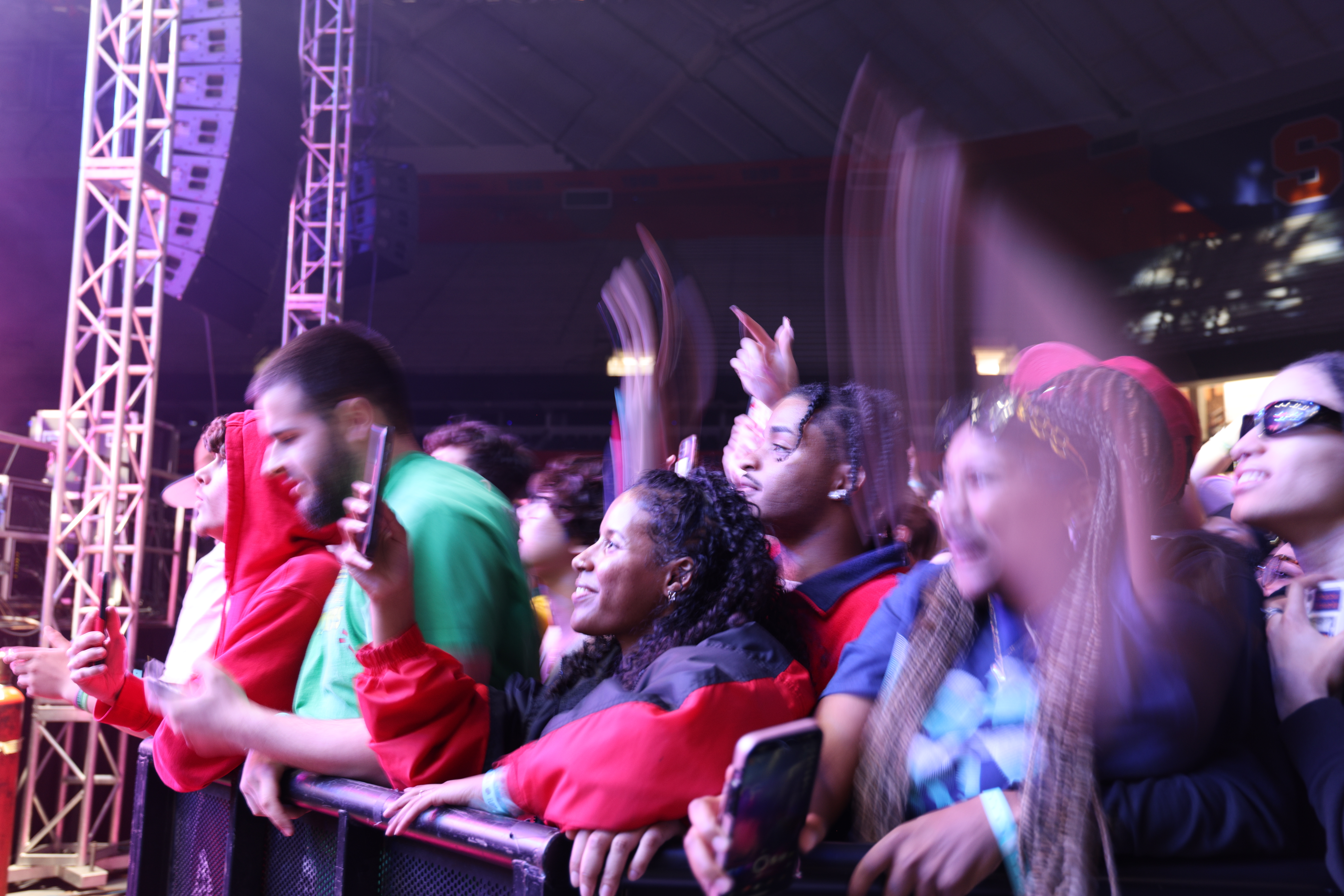 a crowd cheers at a concert 
