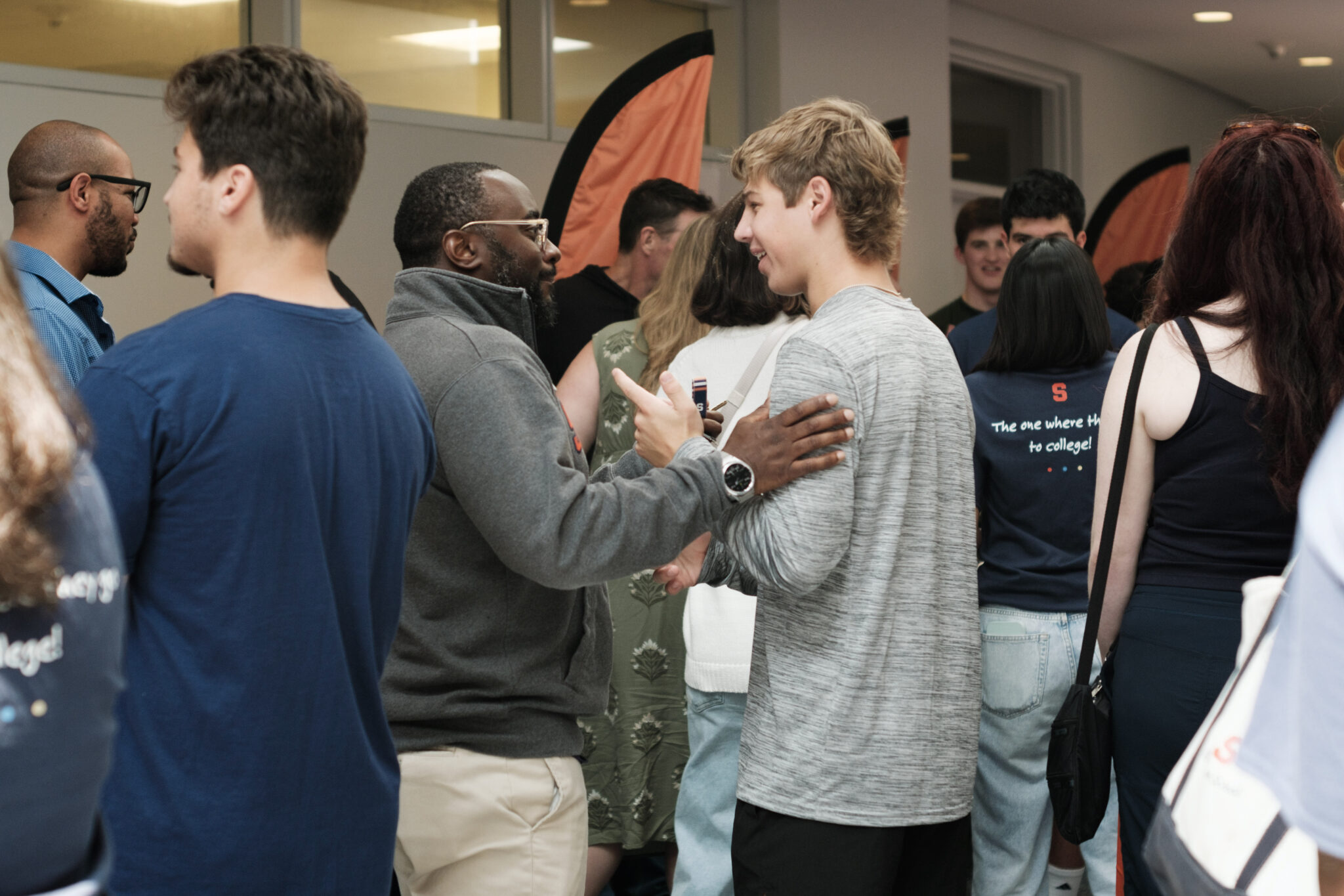 two people talk in a crowded room