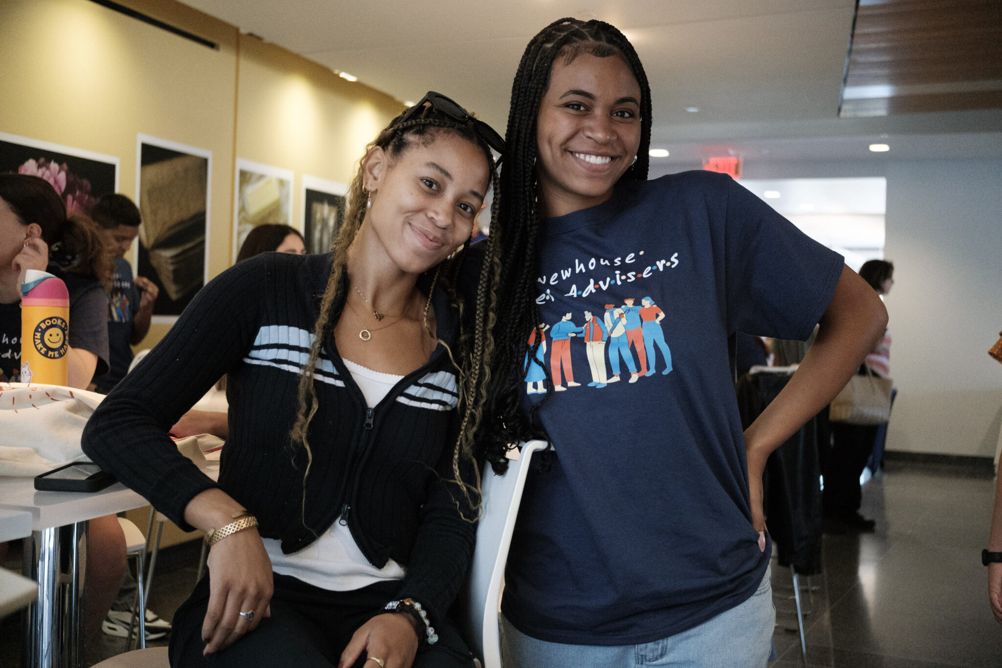 two people stand next to each other and smile