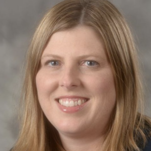 a person with blonde hair poses for a headshot