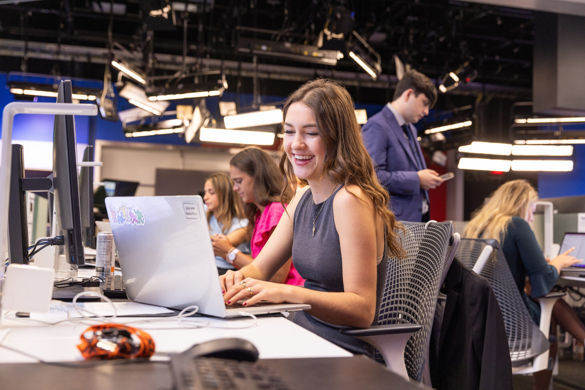 Female student types on laptop in Newhouse News Production class.