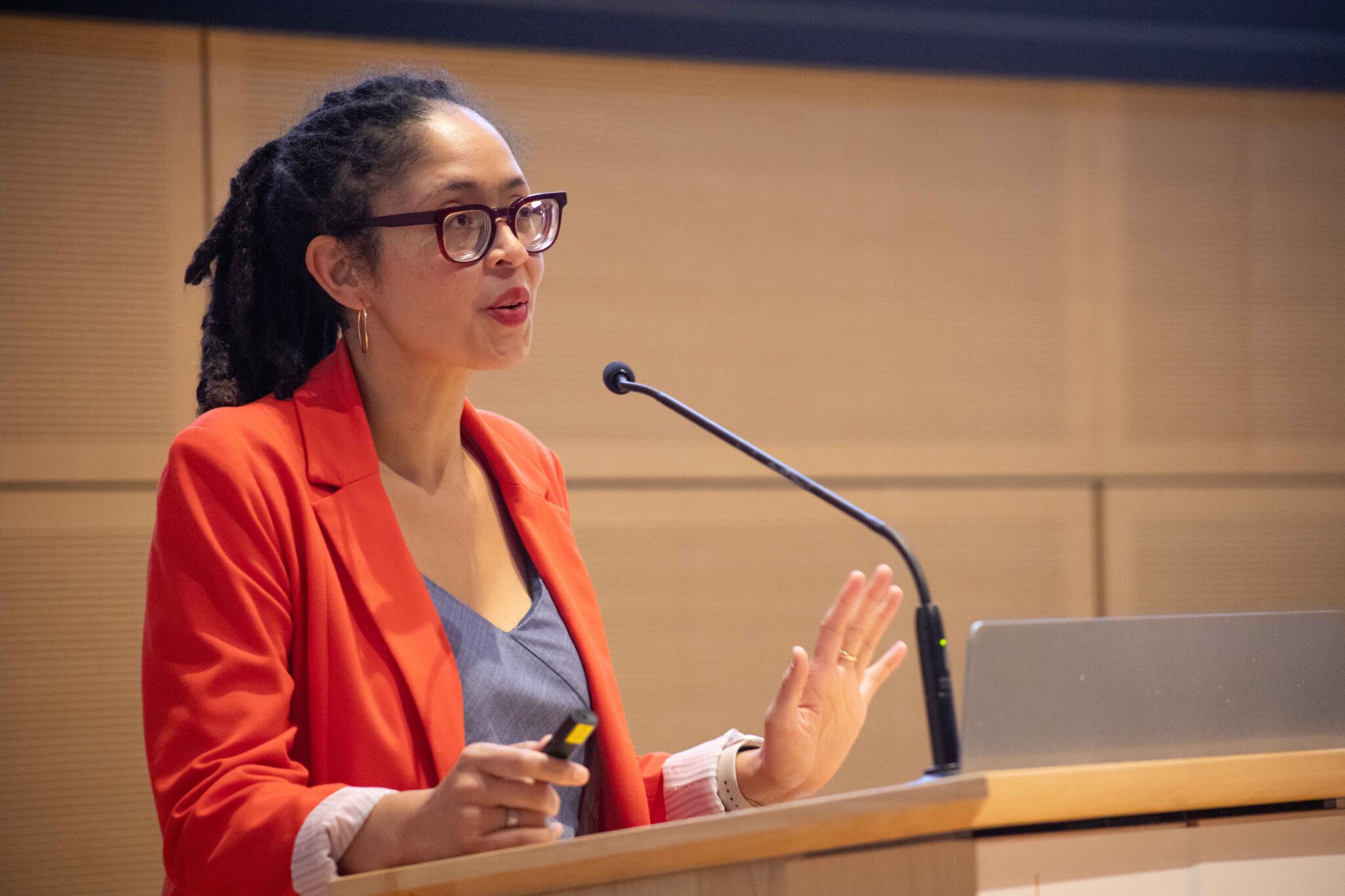 a person stands at a podium and talks  into a microphone