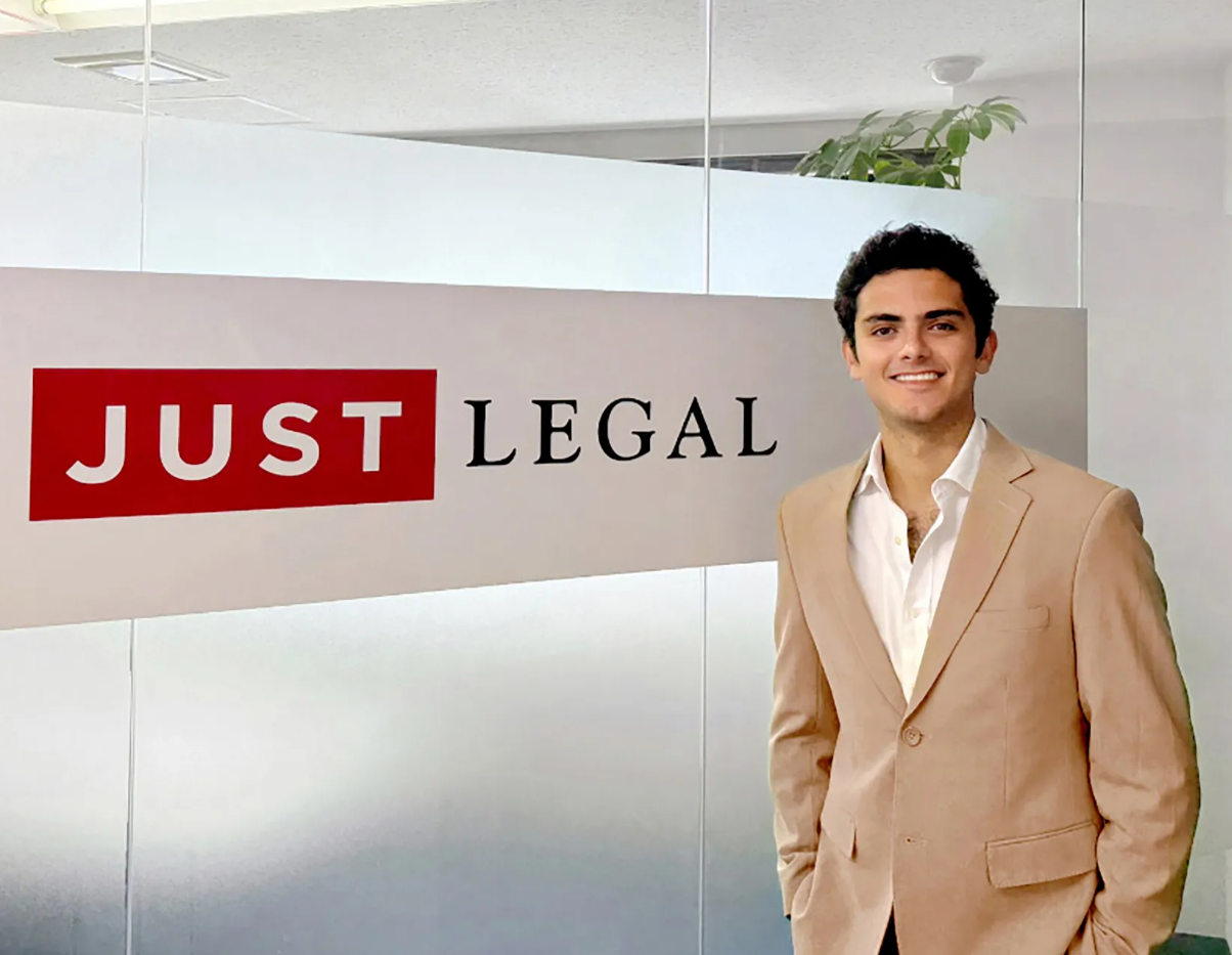 Gustavo Madero stands in front of the Just Legal logo