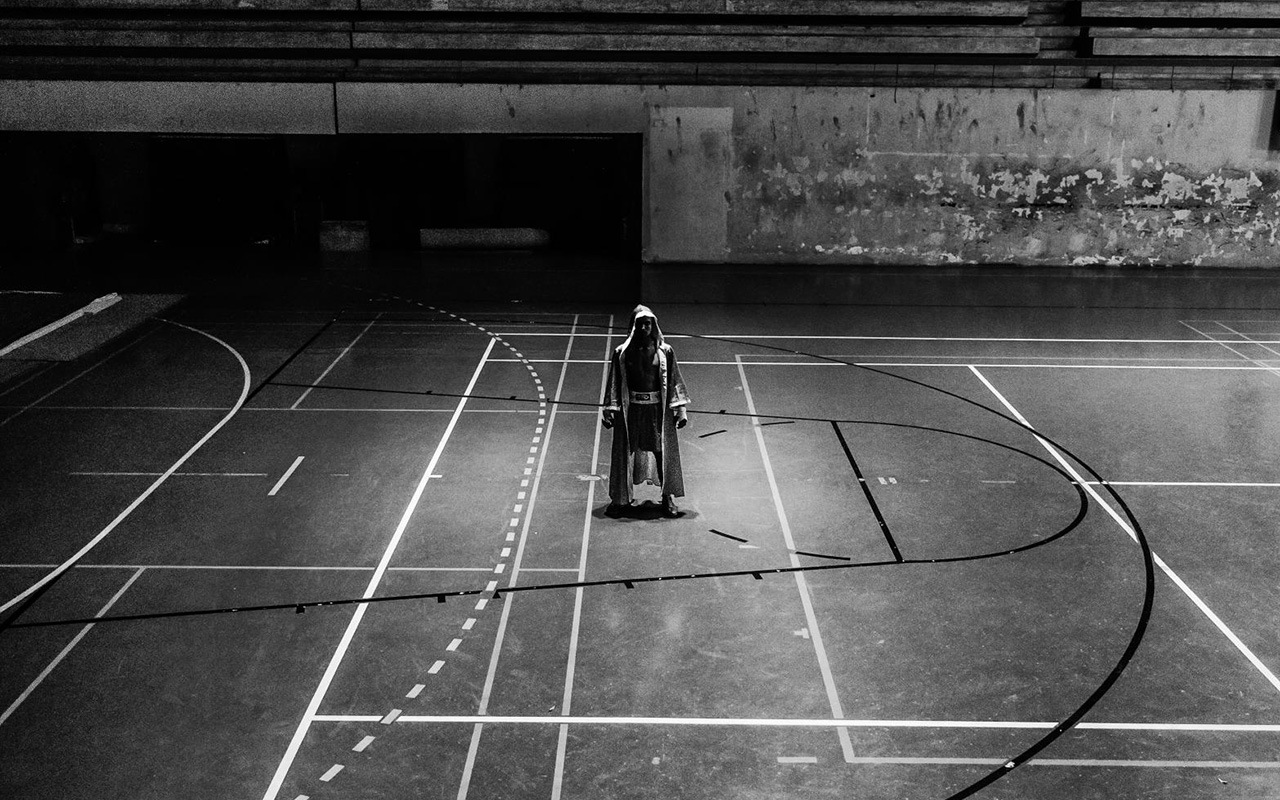 A boxer waits for his match to start in an empty gym.