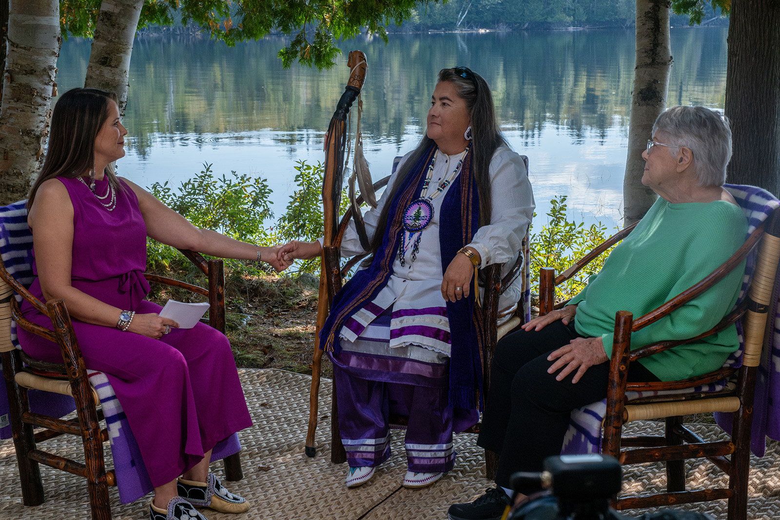 three people sit in chairs as they film an episode of "Rematriated Voices" set at Minnowbrook Conference Center in the Adirondacks.